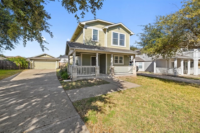 view of front facade with a front yard, an outdoor structure, covered porch, and a garage