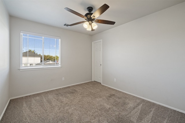 carpeted empty room featuring ceiling fan