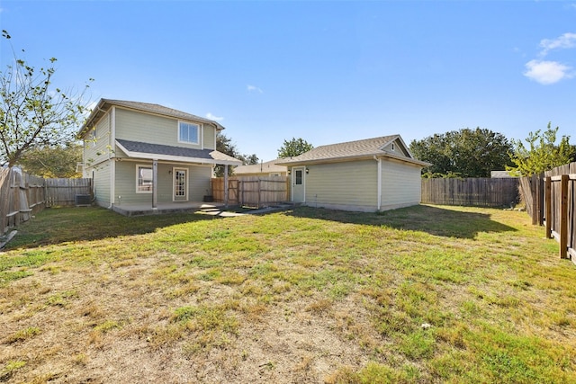 rear view of property featuring a lawn, central air condition unit, and a patio