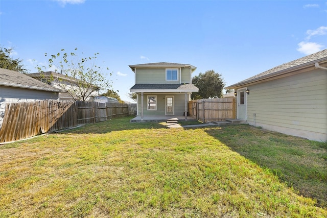 back of house with a yard