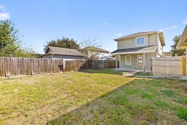 rear view of property with a lawn