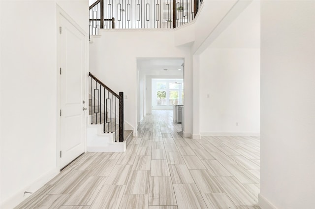 entrance foyer with light hardwood / wood-style floors and a high ceiling