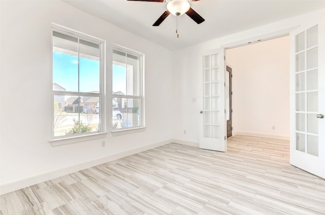 unfurnished room featuring ceiling fan, french doors, and light hardwood / wood-style floors