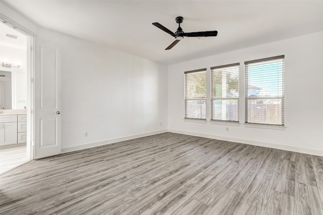 unfurnished room featuring ceiling fan and light wood-type flooring