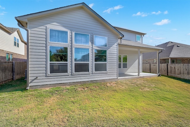 rear view of house with a patio area and a yard