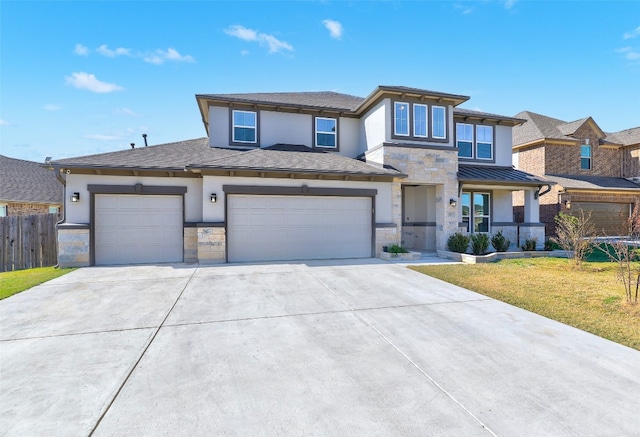 prairie-style house with a garage and a front lawn