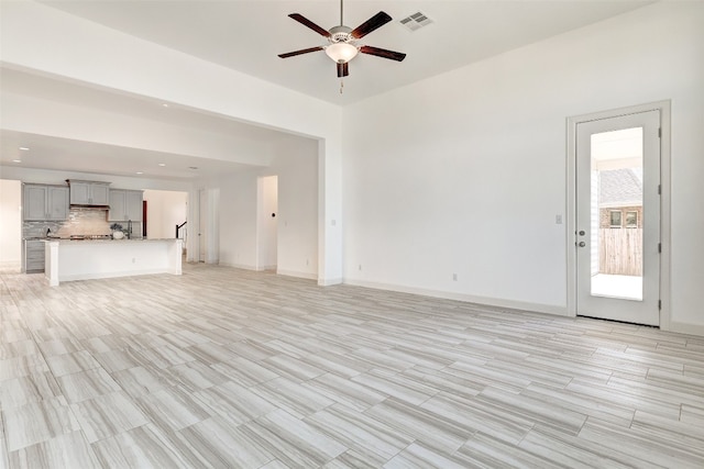 unfurnished living room with ceiling fan and light hardwood / wood-style floors