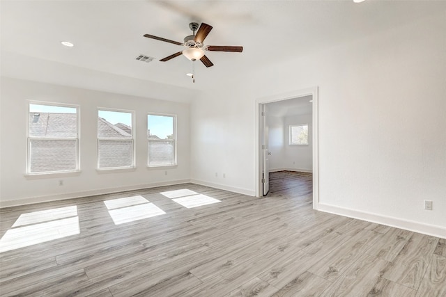 empty room featuring light hardwood / wood-style floors, a wealth of natural light, and ceiling fan