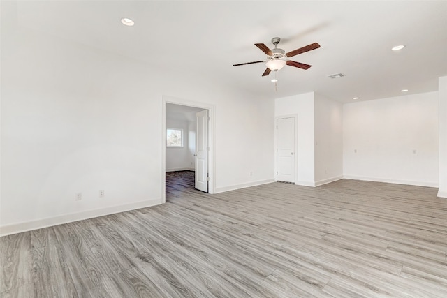 spare room featuring ceiling fan and light wood-type flooring