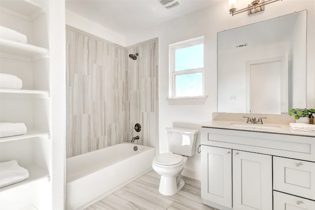 full bathroom featuring vanity, toilet, and tiled shower / bath