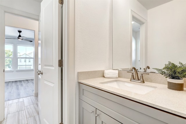 bathroom featuring ceiling fan, vanity, and wood-type flooring