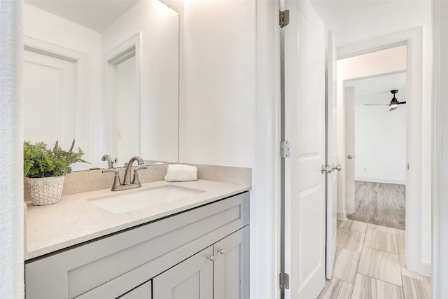 bathroom with hardwood / wood-style floors, vanity, and ceiling fan