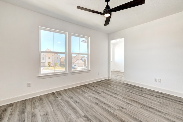 unfurnished room with ceiling fan and light hardwood / wood-style flooring