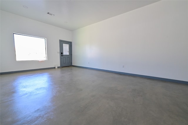 unfurnished room featuring concrete floors