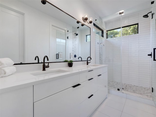 bathroom with tile patterned flooring, vanity, and a shower with shower door