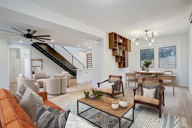 living room with light hardwood / wood-style flooring and a notable chandelier