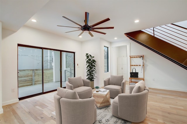 living room with light hardwood / wood-style floors and ceiling fan