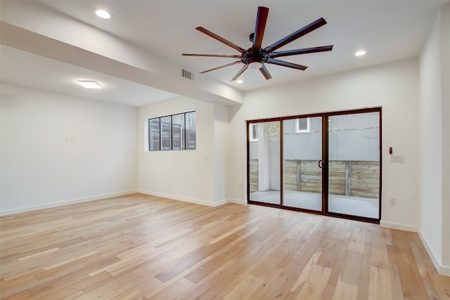 spare room featuring light wood-type flooring and ceiling fan