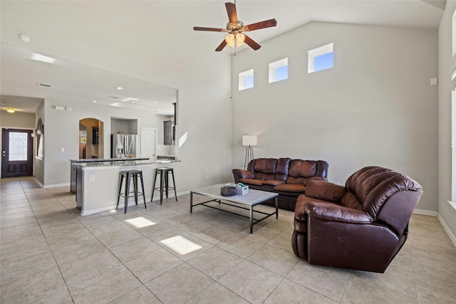 tiled living room with high vaulted ceiling and ceiling fan