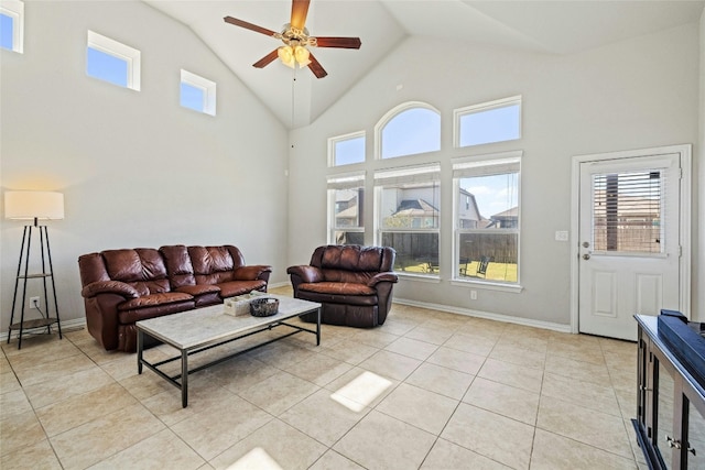 tiled living room with ceiling fan and high vaulted ceiling