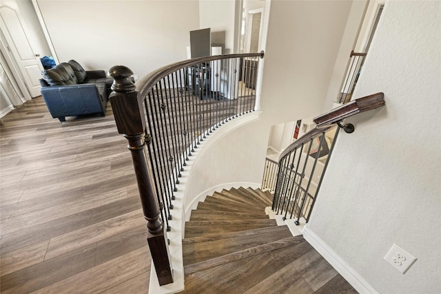 staircase with hardwood / wood-style flooring