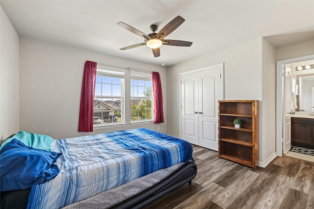 bedroom featuring a closet, ensuite bathroom, dark hardwood / wood-style flooring, and ceiling fan