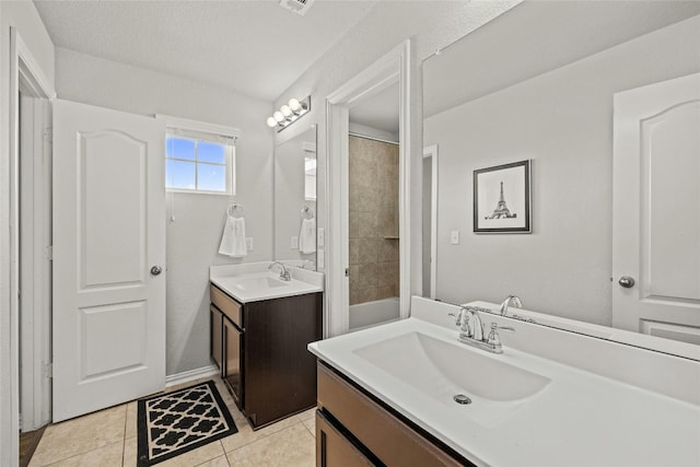 bathroom with tile patterned floors, vanity, and a textured ceiling