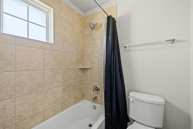 bathroom featuring shower / bath combo and toilet