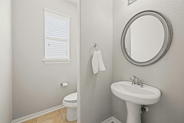 bathroom with tile patterned flooring and toilet