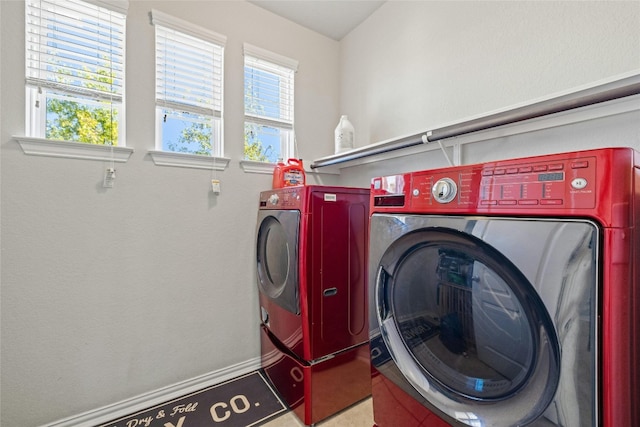 washroom with plenty of natural light and washer and dryer