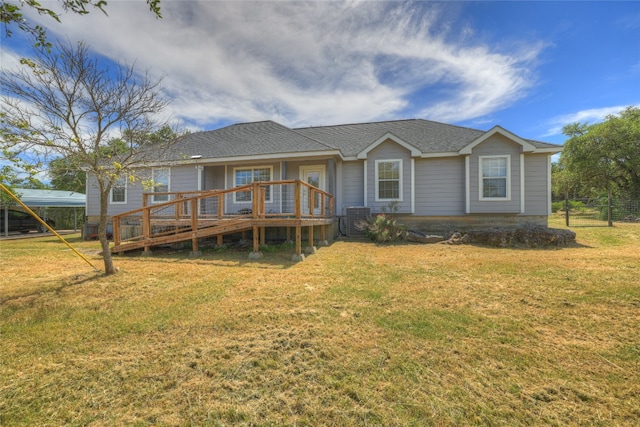 back of property featuring a lawn, a wooden deck, and central AC unit