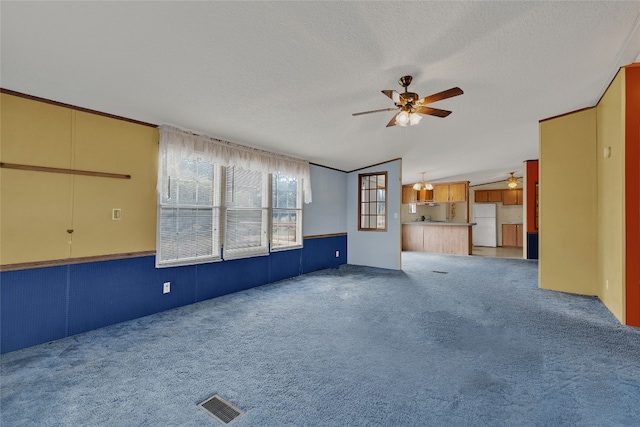 unfurnished living room with a textured ceiling, ceiling fan, carpet, and lofted ceiling