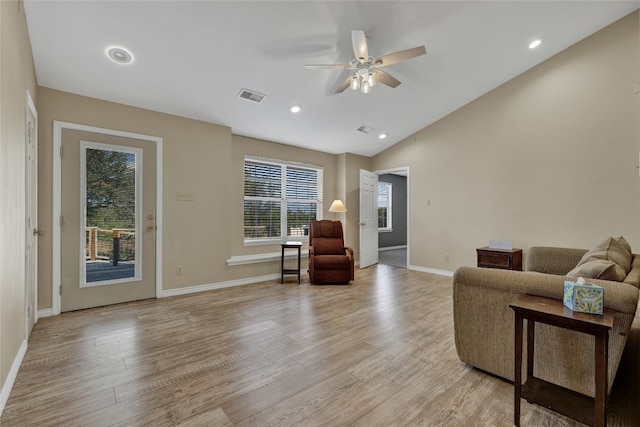 living room with ceiling fan, vaulted ceiling, and light hardwood / wood-style flooring