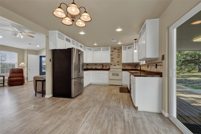 kitchen featuring stainless steel refrigerator, light hardwood / wood-style flooring, white range with electric cooktop, decorative backsplash, and white cabinets