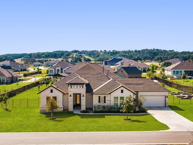 view of front of house with a garage and a front yard