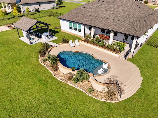 view of pool with a gazebo, exterior bar, a patio, and a lawn