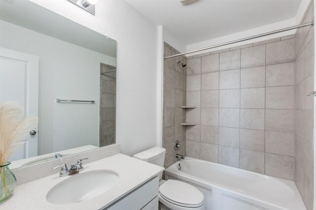 full bathroom with vanity, toilet, and tiled shower / bath