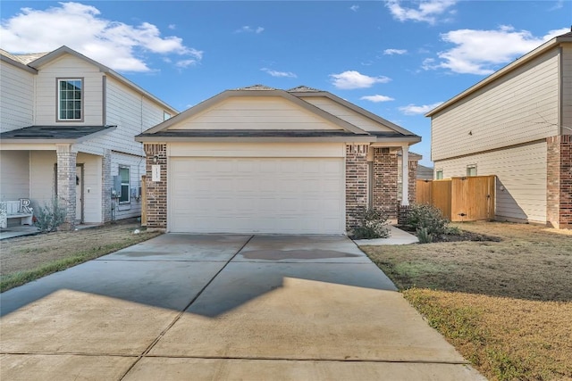 view of front of home featuring a garage, driveway, brick siding, and fence