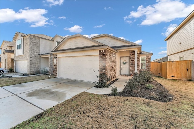 view of front of home with brick siding, an attached garage, a front yard, fence, and driveway