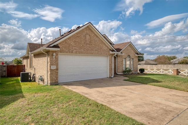 view of front of house with brick siding, concrete driveway, a front yard, central AC, and fence