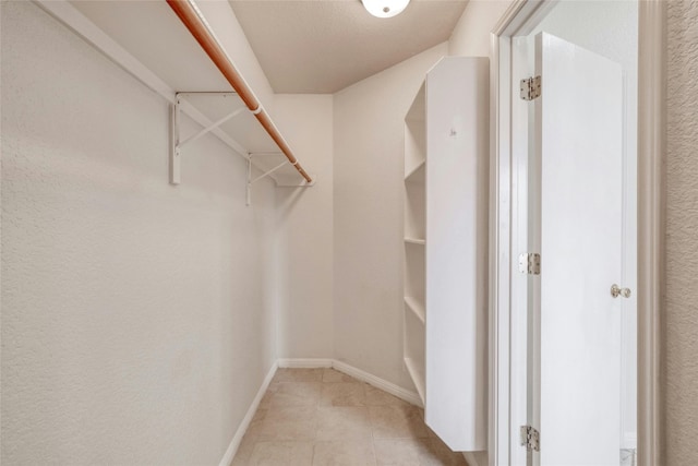 walk in closet featuring light tile patterned floors