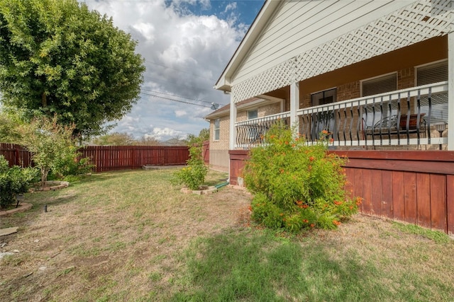 view of yard with a porch and fence