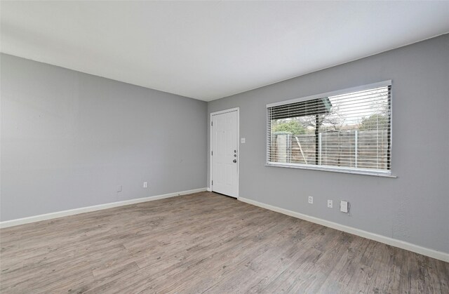 spare room with light wood-type flooring