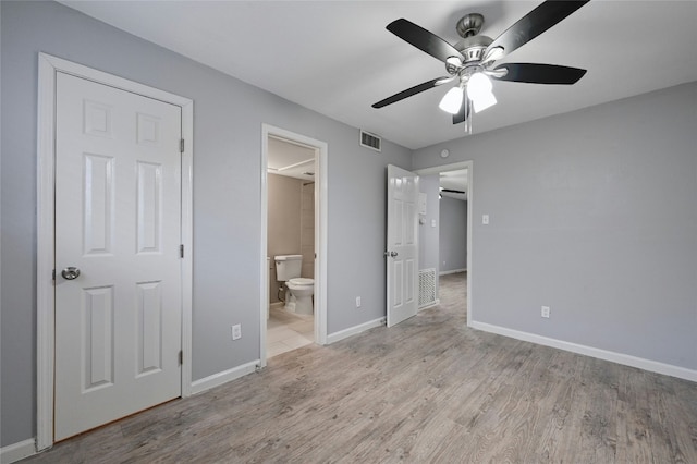 unfurnished bedroom with connected bathroom, ceiling fan, and light hardwood / wood-style flooring