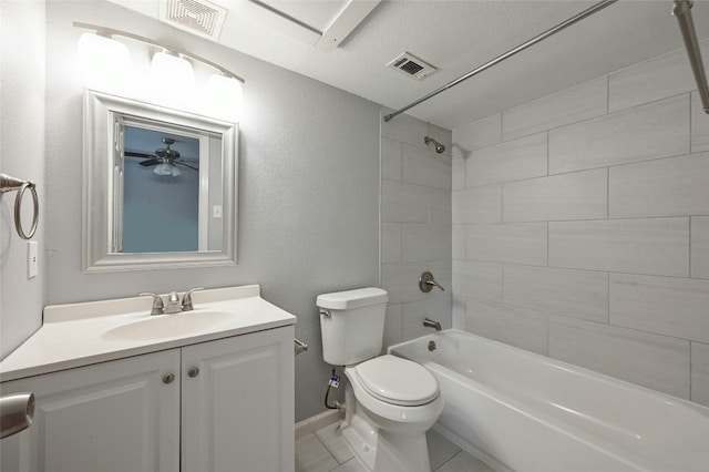 full bathroom featuring ceiling fan, tiled shower / bath combo, tile patterned flooring, toilet, and vanity