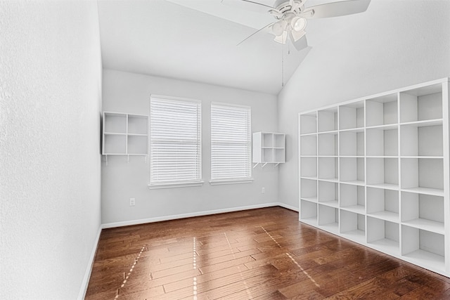 empty room with vaulted ceiling, ceiling fan, and dark hardwood / wood-style floors