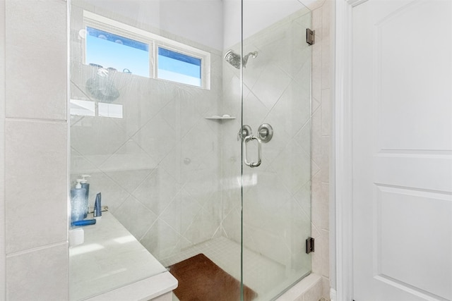 bathroom with a shower with door