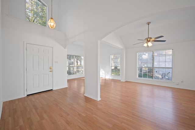 foyer with light wood-type flooring, ceiling fan, and vaulted ceiling