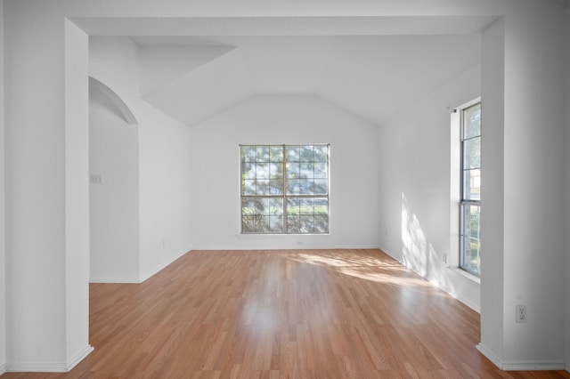 unfurnished room with lofted ceiling and light hardwood / wood-style floors