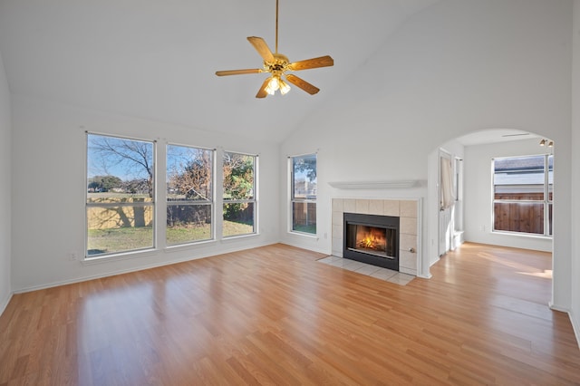 unfurnished living room with high vaulted ceiling, light hardwood / wood-style flooring, and ceiling fan